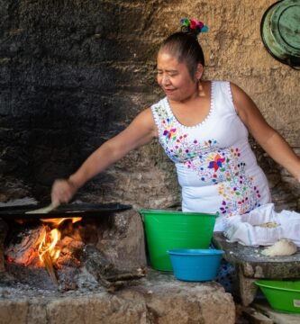 woman in white and pink floral tank top cooking